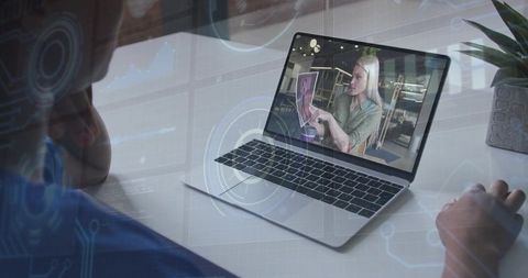 Watching Virtual Presenter Holding Tablet during Remote Training on Laptop Screen