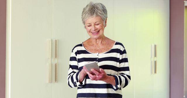 Happy Senior Woman Using Tablet in Modern Home - Download Free Stock Images Pikwizard.com