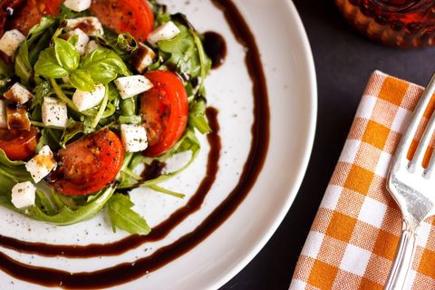 Arugula Caprese Salad with Cherry Tomatoes Mozzarella Cubes and Balsamic Glaze