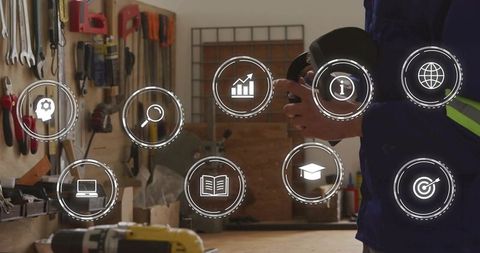Worker holding angle grinder in workshop with safety, training and tools icons overlay
