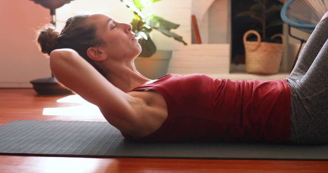 Woman practicing abdominal exercises at home on yoga mat - Download Free Stock Images Pikwizard.com