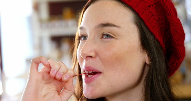 Beautiful woman eating a cherry in cafe 4k