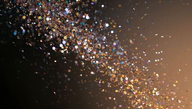 Shimmering diagonal ribbon of holographic glitter with hexagonal bokeh and golden prism sparkle