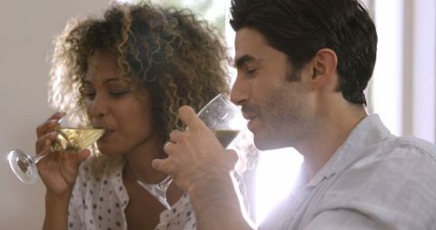 Cheerful Young Couple Enjoying Glasses of White Wine Together - Download Free Stock Images Pikwizard.com