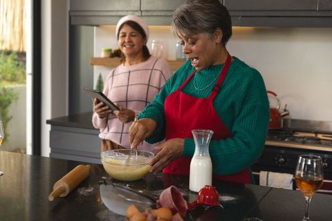 Mother and daughter baking and enjoying quality time in modern kitchen