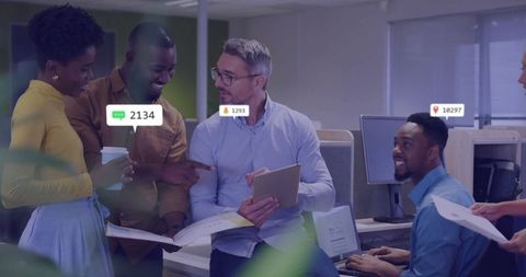 Team reviewing digital data with notification icons in modern office