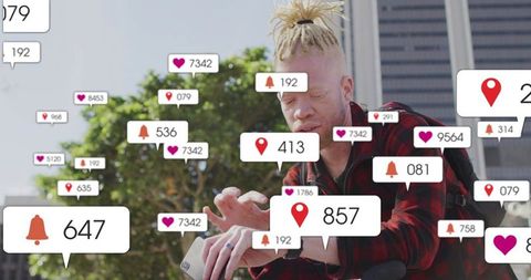 Man with light dreadlocks tapping smartphone amid floating social media alert overlays