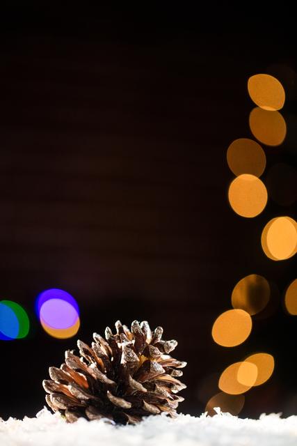 Pine Cone on Snow with Festive Bokeh Lights - Download Free Stock Photos Pikwizard.com