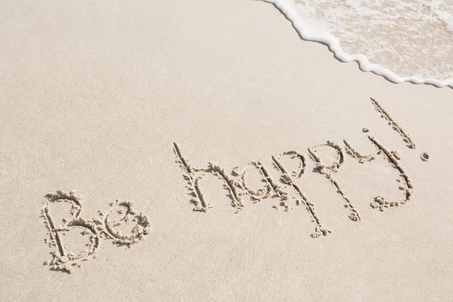Be happy written on sand at beach