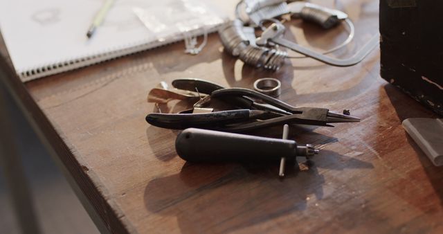 Close up of tools on wooden table in jewellery workshop. Jewellery, tools, enterpreneurship and small business.
