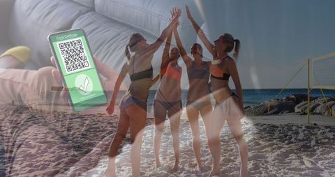 Women celebrating beach holiday with digital vaccine passport concept