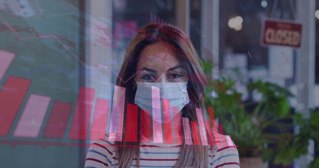 Businesswoman wearing face mask analyzing financial bar graphs overlaid on the image. Reflects new norms in work environments due to the Covid-19 pandemic. Suitable for articles on remote work, financial trends, and pandemic impact on business.