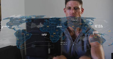 Man interacting with holographic world map interface at home for global data visualization