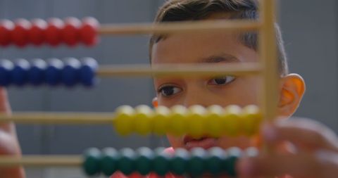 Child Concentrating on Abacus in Classroom - Download Free Stock Images Pikwizard.com