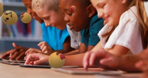 Diverse Children Engaging with Interactive Learning Tablets in Classroom