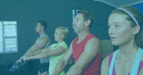 Diverse group training with kettlebells in gym