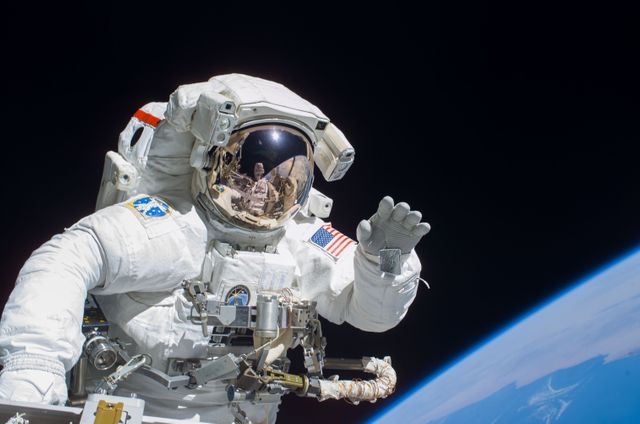 S115-E-05753 (12 Sept. 2006) --- Astronaut Joseph R. Tanner, STS-115 mission specialist, waves toward the digital still camera of his spacewalk colleague, astronaut Heidemarie M. Stefanyshyn-Piper as the two share extravehicular activity (EVA) duties during the first of three scheduled spacewalks. The STS-115 astronauts and the Expedition 13 crewmembers are joining efforts this week to resume construction of the International Space Station.