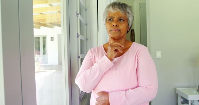 Senior Woman Reflecting While Looking Out Window in Living Room - Download Free Stock Images Pikwizard.com