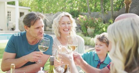 Family Enjoying Outdoor Dinner with Wine in Sunlit Garden - Download Free Stock Images Pikwizard.com