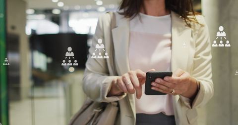 Woman in Office Using Smartphone with Networking Icons