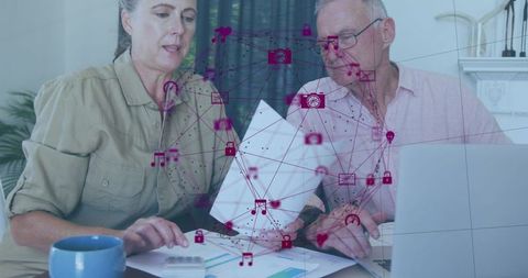 Senior couple analyzing financial documents with digital overlay