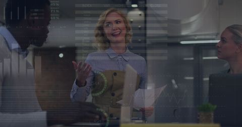 Diverse business team analyzing digital statistics in office