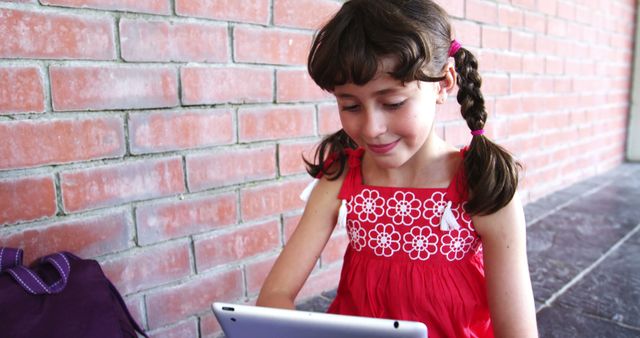 Schoolgirl Engaged with Digital Tablet in Hallway - Download Free Stock Images Pikwizard.com