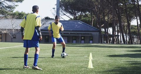 Youth soccer players practicing dribbling skills on field