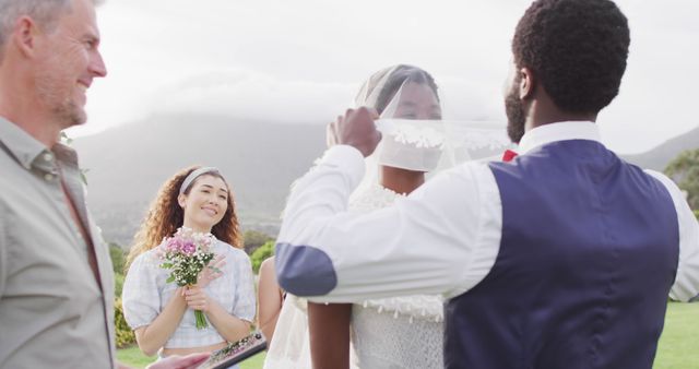 Happy african american married couple with diverse friends. Wedding day, friendship, inclusivity and lifestyle concept.