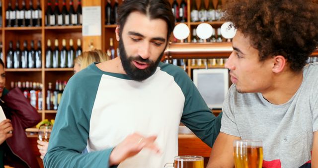 Diverse friends enjoying conversation at the pub - Download Free Stock Images Pikwizard.com