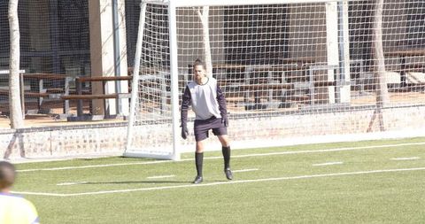 Focused Goalkeeper Ready for Soccer Action on Field