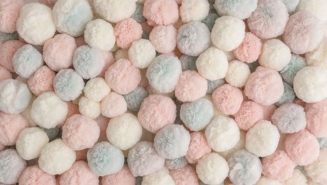 Pastel pom-pom texture creating soft plush backdrop for crafts, nursery decor, textiles