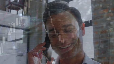 Businessman Engaged in Call with Financial Data Overlay