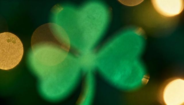 Glowing shamrock bokeh featuring golden lights for st patrick's day festive background