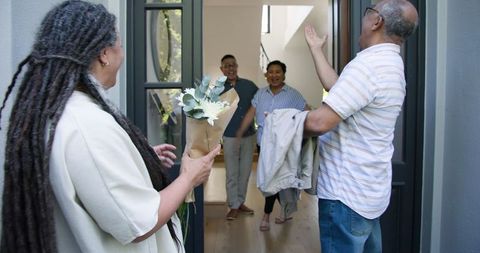 Joyful Friends Welcome Teem with Laughter and Flowers