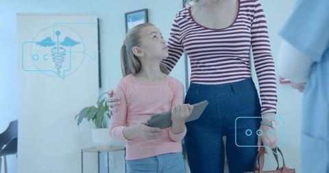 Mother and Daughter Consulting Doctor While Holding Tablet in Medical Clinic, Digital Health Focus