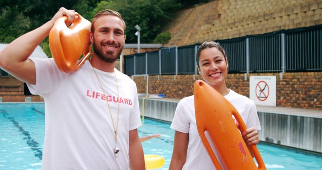 Smiling Lifeguards Standing by Swimming Pool with Rescue Buoys - Download Free Stock Images Pikwizard.com