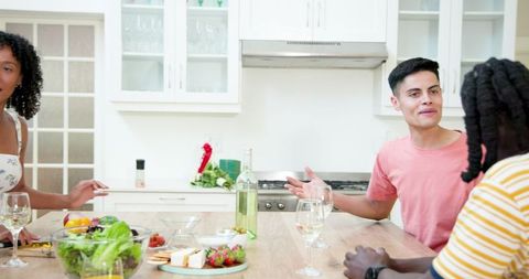 Friends Enjoying Wine and Conversation in Modern Kitchen