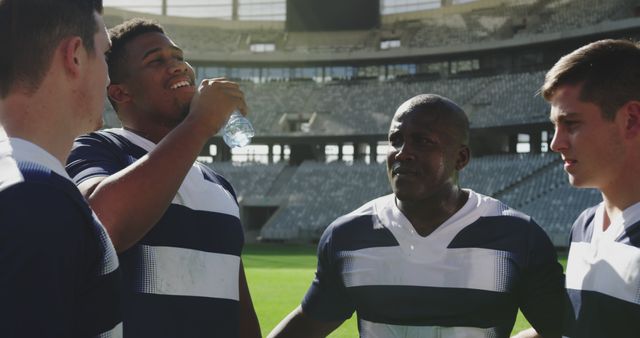 Rugby Team Hydrating and Bonding on Stadium Field - Download Free Stock Images Pikwizard.com