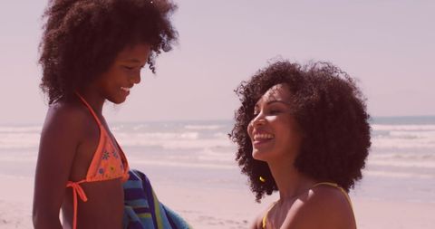 Mother and Daughter Smiling Together by the Seaside