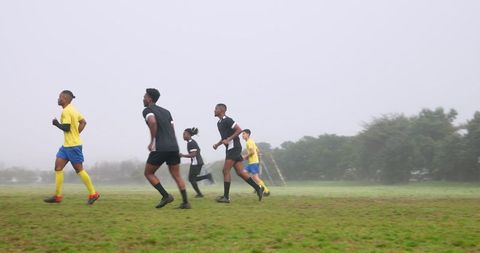 Youth Soccer Players Training on Misty Field
