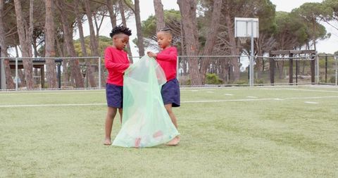 Children picking litter on sports field promoting environmental awareness