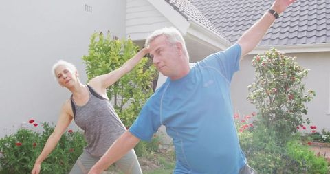 Senior couple enjoys outdoor stretching exercises for healthy lifestyle