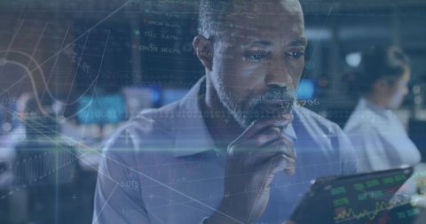 African American Businessman Analyzing Data on Tablet