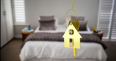 Luxury Home Symbolized by Golden House Key in Modern Bedroom