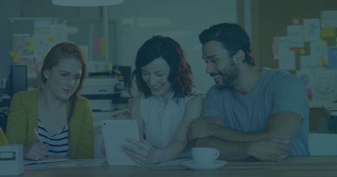 Collaborative Team Engaged in Creative Work Using Tablet in Modern Office