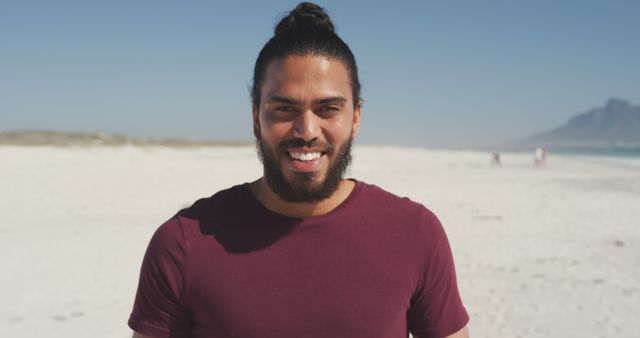 Portrait of hispanic smiling man standing on beach. Summer, free time, chill, vacation, happy time.