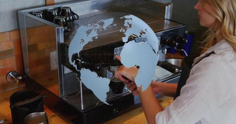 Barista tamping espresso with world map overlay representing global coffee culture