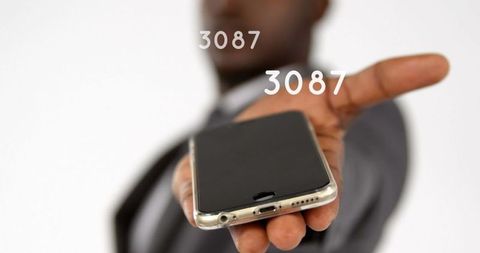 Businessman Displaying Smartphone with Floating Numbers