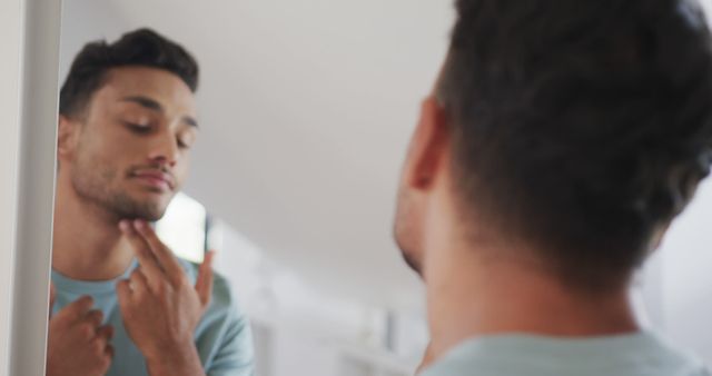 Man Looking at Reflection and Checking Facial Hair Condition - Download Free Stock Images Pikwizard.com